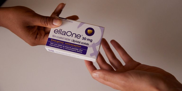 Picture of hands passing a package of ellaOne to each other